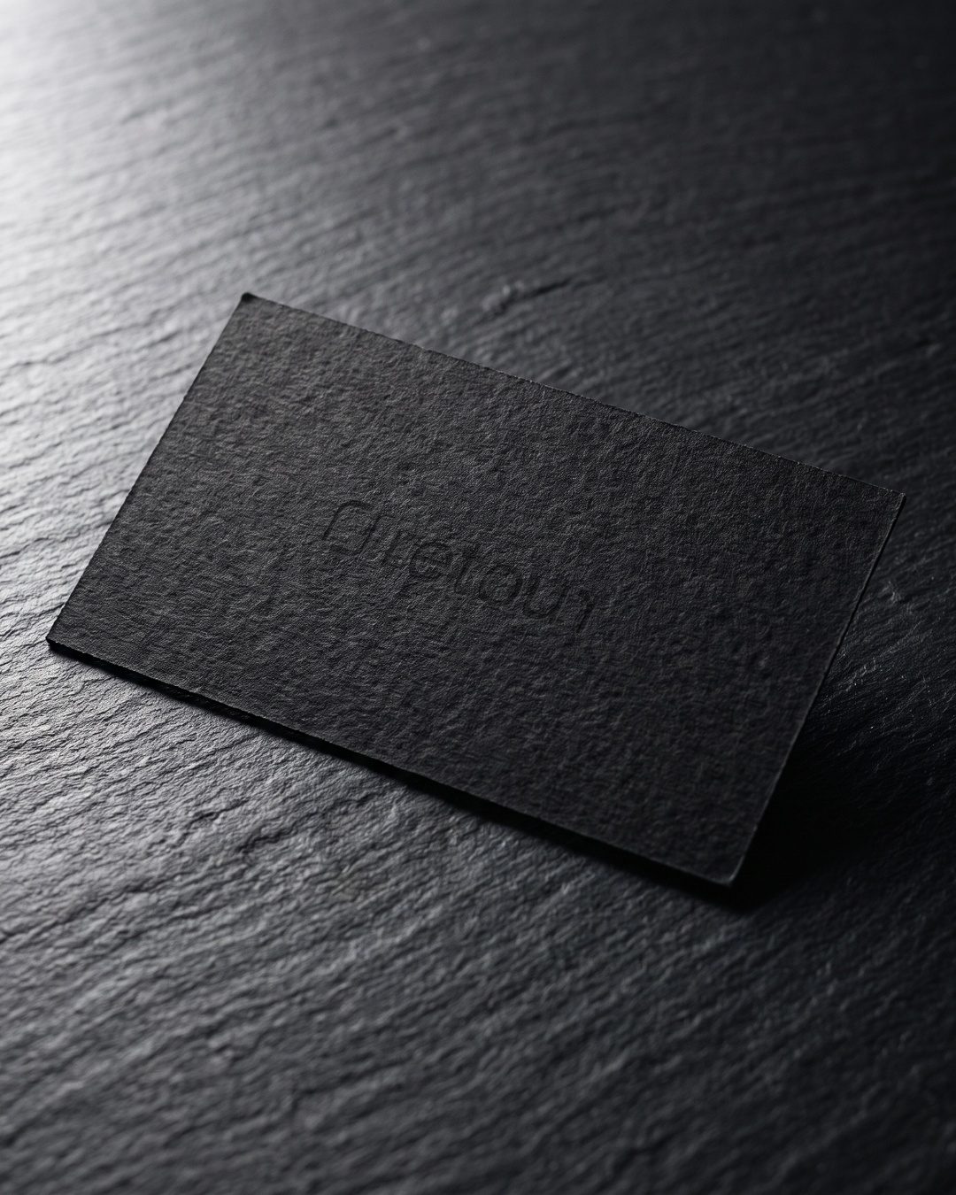 Retour logo blind debossed on a black card