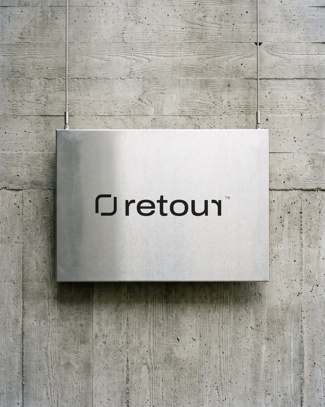 Retour sign in brushed aluminium on concrete