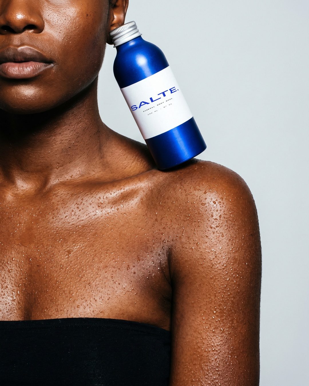 SALTE bottle resting on a shoulder